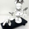 Minnie & Dog Matte white Minnie sculpture with silver chrome bow and luxury handbag next to a matching white balloon dog with pearl necklace on a black wooden base.