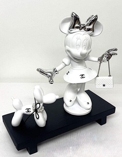 Minnie & Dog Matte white Minnie sculpture with silver chrome bow and luxury handbag next to a matching white balloon dog with pearl necklace on a black wooden base.