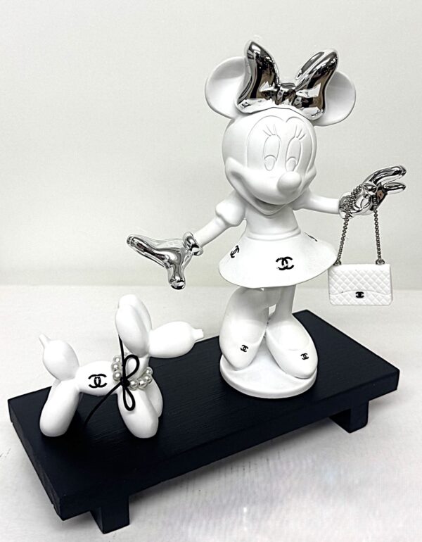 Minnie & Dog Matte white Minnie sculpture with silver chrome bow and luxury handbag next to a matching white balloon dog with pearl necklace on a black wooden base.