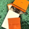 Originele Vintage Hermès Portemonnee in iconisch oranje compleet met doosje en lint
